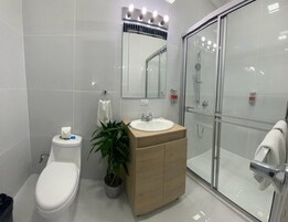 Bañera con ducha, secador de pelo, piso con calefacción en el baño