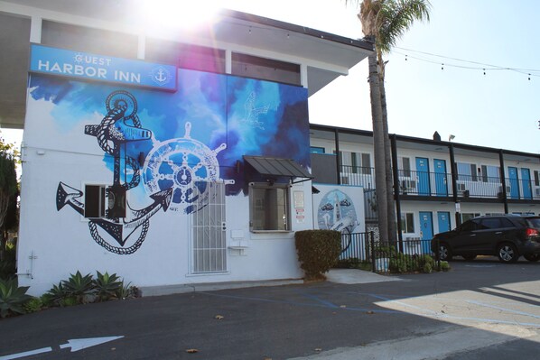 A building with a mural of an anchor and ship wheel, labeled "Guest Harbor Inn." - The Guest Harbor Inn - Port of Los Angeles San Pedro (San Pedro)