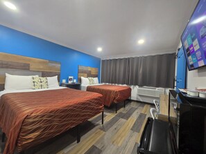 A hotel room with two beds, a desk, a TV, and a window with curtains. - The Guest Harbor Inn - Port of Los Angeles San Pedro (San Pedro)