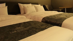 A hotel room with two beds, each with a dark headboard and white bedding. - Line Plus Hotel (Gimpo)