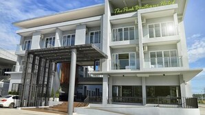 A modern hotel with a flat roof, multiple balconies, and a prominent sign reading "The Peak Boutique Hotel". - The Peak Boutique Hotel (Phra Phrom)
