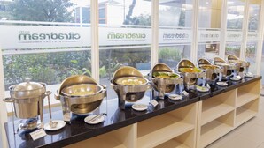 A buffet setup with various food containers and a sign indicating 'JAGUNG' on a counter. - Hotel Citradream Bintaro (South Tangerang)