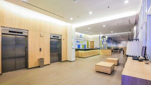 A modern lobby with two elevators, a reception desk, and a counter with a sign reading "CitraDream". - Hotel Citradream Bintaro (South Tangerang)