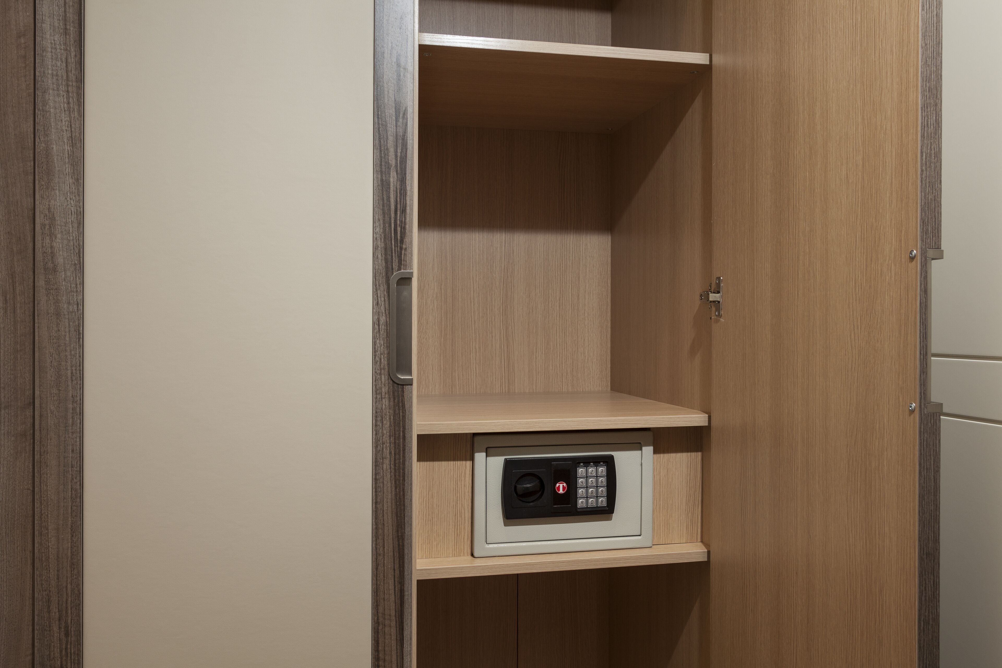 A wooden wardrobe with a built-in safe.