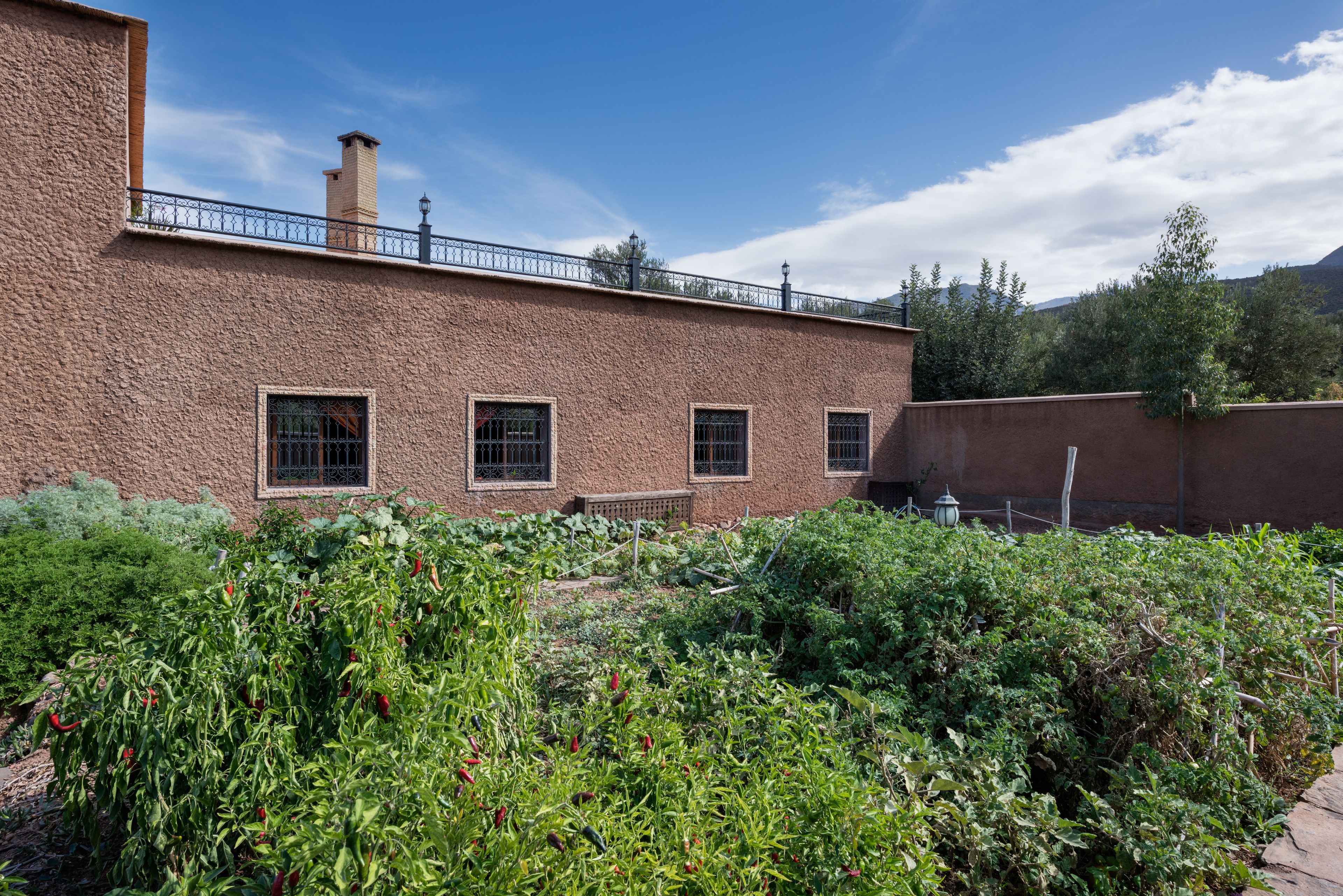 A brick building with a garden in front.