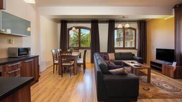 Apartamento luxo | Área de estar | TV de tela plana