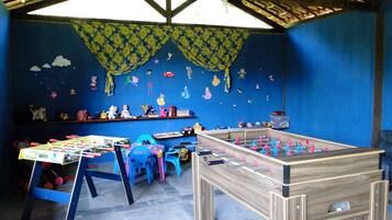 Relax in a fun space with a foosball table, bookshelves, and unique wall decor.