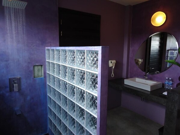 A bathroom with a shower, a sink, a mirror, and a glass block partition. - MEN's Resort & Spa - Caters to Gay Men (Siem Reap)