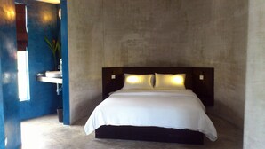 A modern bedroom with a large bed, a nightstand, and a wall-mounted light fixture. - MEN's Resort & Spa - Caters to Gay Men (Siem Reap)