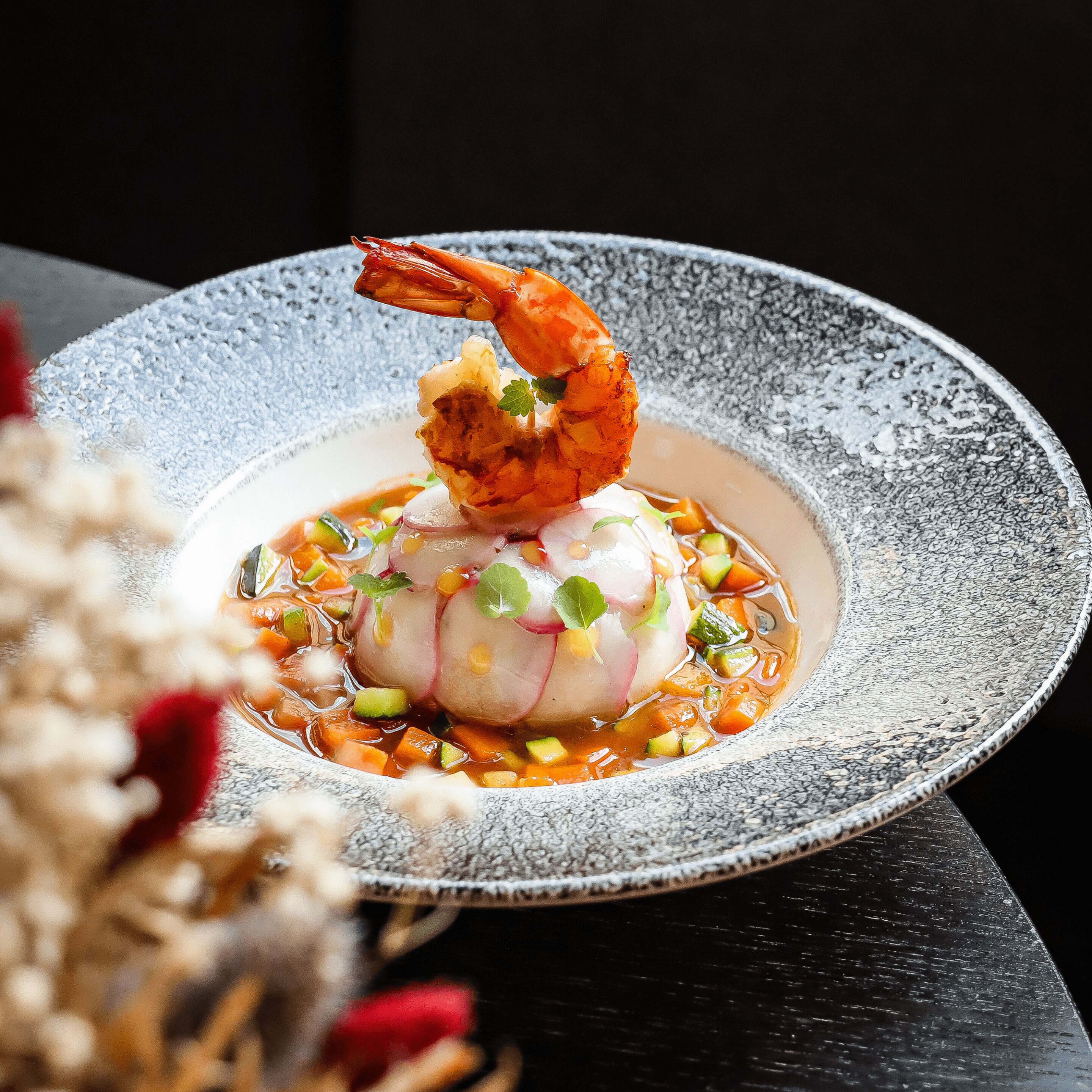 A seafood dish on a textured plate.