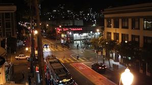 A nighttime cityscape with a prominent building featuring a red neon sign. - Union Hotel (San Francisco)