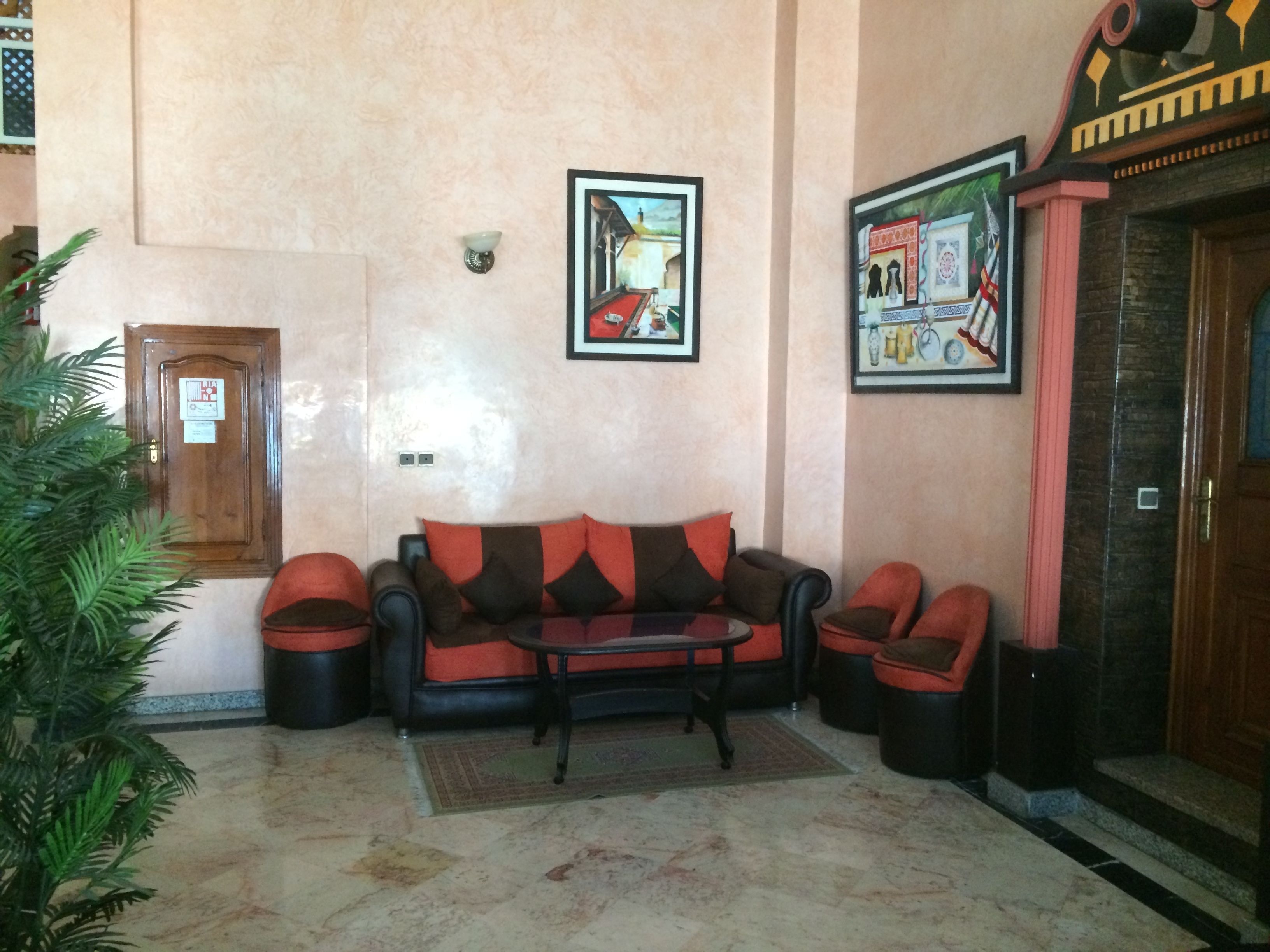 A living room with a sofa set, a coffee table, and two wall-mounted lamps.