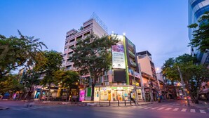 A multi-story building with a ground-floor restaurant and a sign indicating it is open daily. - For You Residence (Bangkok)