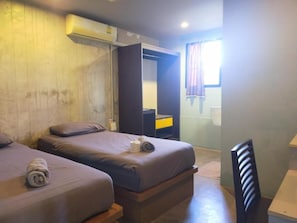 A room with two beds, a wardrobe, a desk, and a window with curtains. - 9 Hostel - Hostel (Chiang Mai)