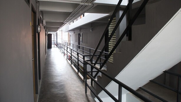 A corridor with a staircase and a railing. - 9 Hostel - Hostel (Chiang Mai)