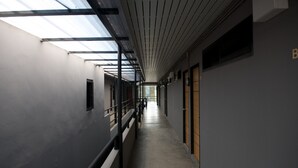 A long, narrow corridor with a skylight ceiling and a concrete floor. - 9 Hostel - Hostel (Chiang Mai)