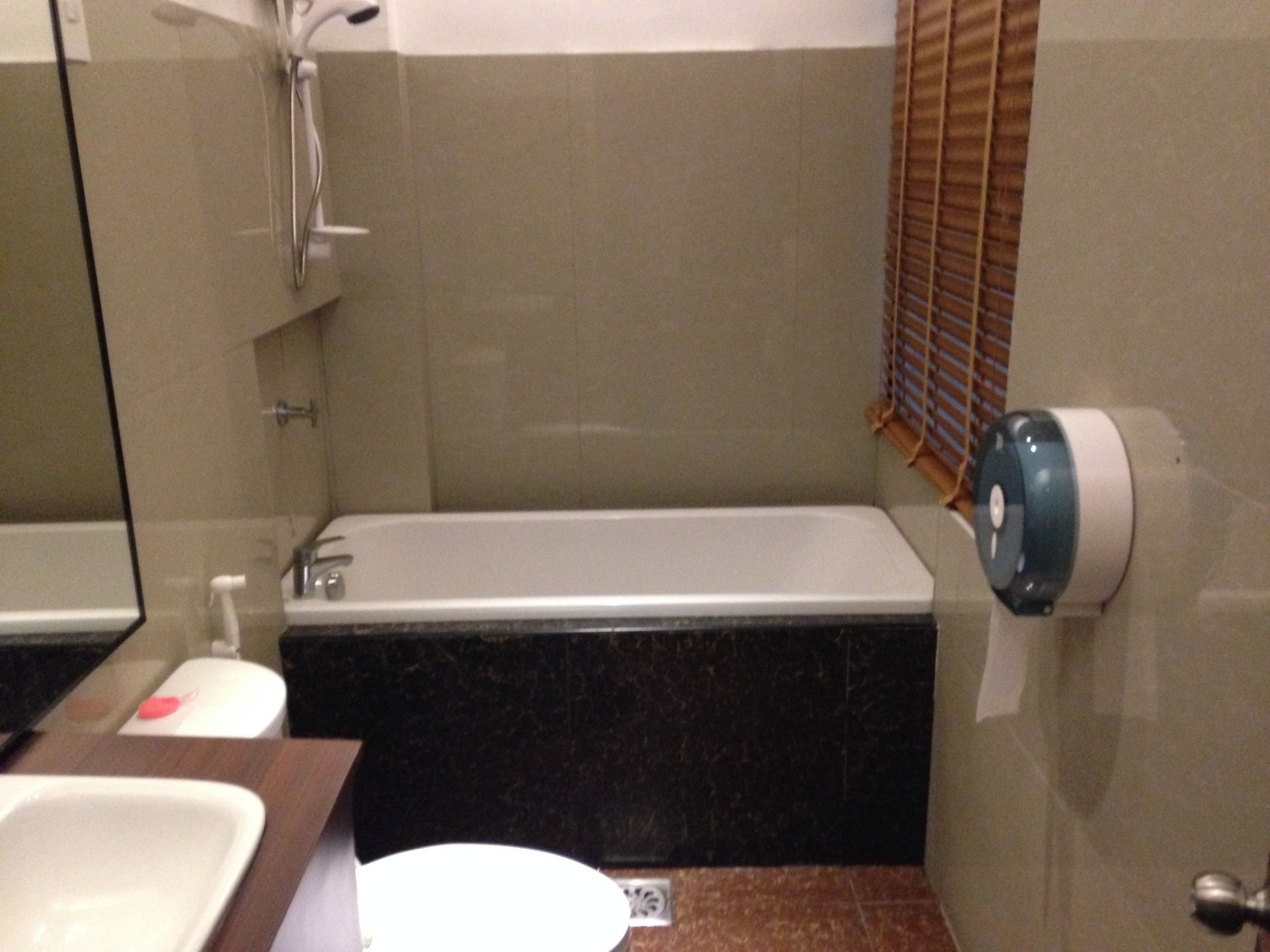 A bathroom with a bathtub, a sink, and a toilet.