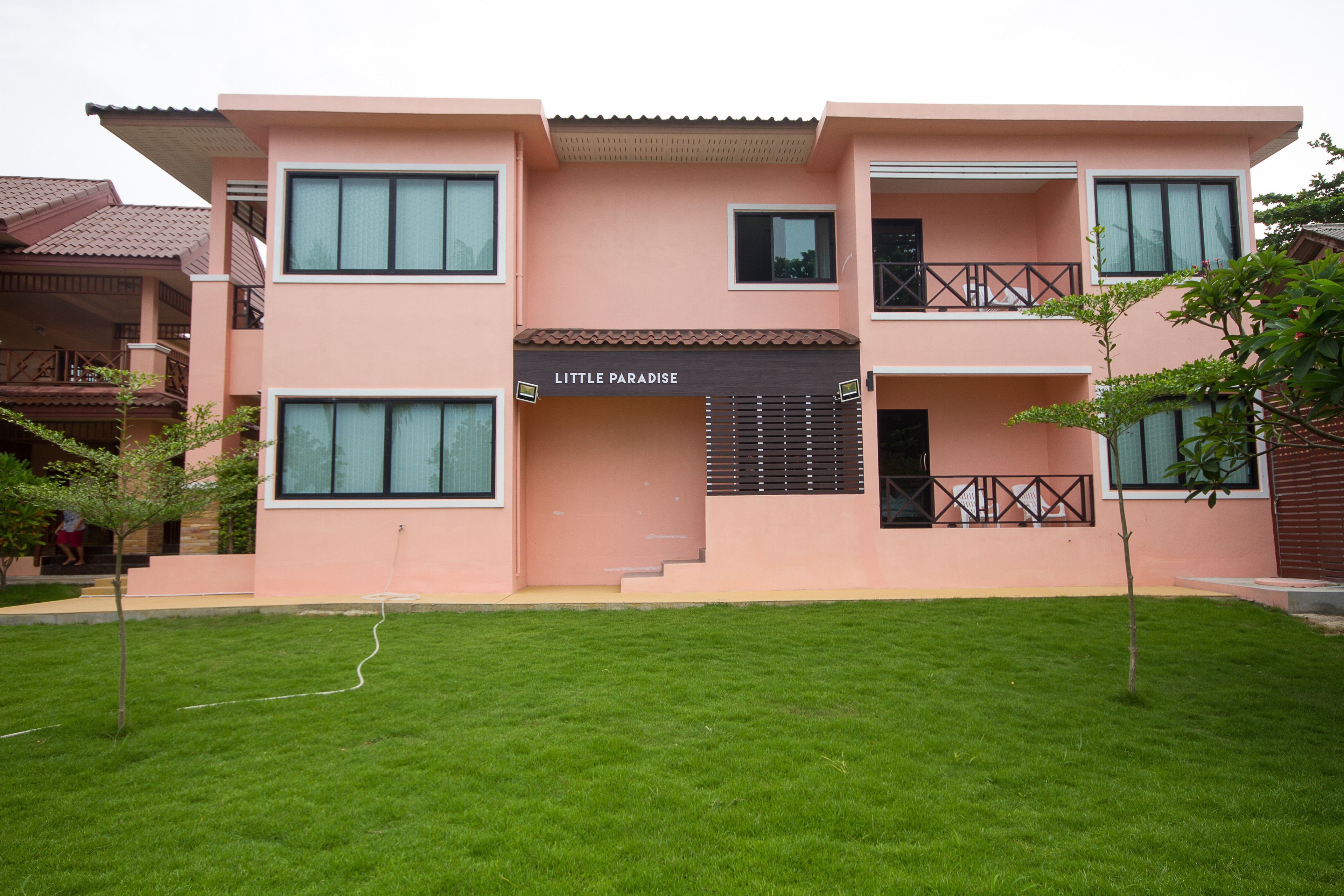 A two-story building with a sign reading "Little Paradise."