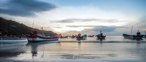 A calm harbor with several boats anchored.
