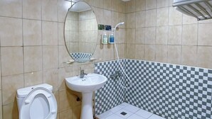 A bathroom with a toilet, sink, and shower. - A22 Wei Lu Hotel (Taoyuan City)