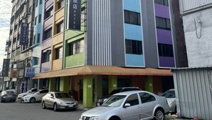 A multi-story hotel with a modern design, featuring a mix of colors on the facade. - A22 Wei Lu Hotel (Taoyuan City)