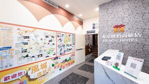 A hotel reception area with a brick wall and a map display. - Peach Hotel (Hsinchu)