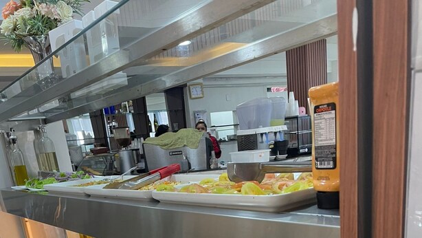 A buffet with various food options including pasta, rice, and vegetables. - Hotel Family (São Paulo)