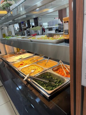 A buffet with various food options including pasta, rice, and vegetables. - Hotel Family (São Paulo)