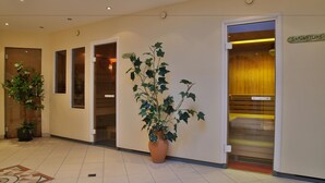 A hotel lobby with a potted plant, a reception desk, and an elevator. - Pension Neururer (Soelden)