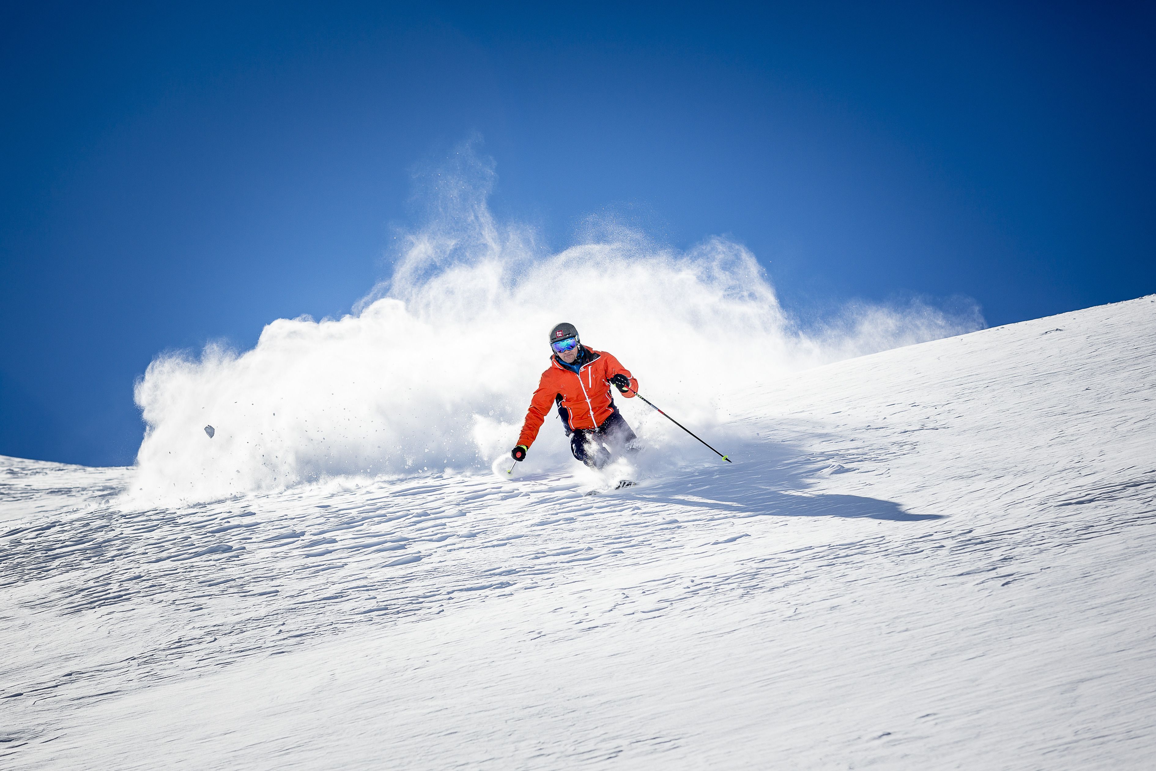 A skier in motion on a snowy slope.