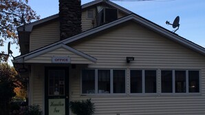 A building with a sign indicating an office and a Hamilton Inn.