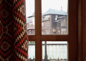 A window view of a building with multiple stories, balconies, and a metal roof. - Resort Kasprowy Wierch (Zakopane)