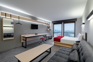 Escritorio, cortinas blackout y tabla de planchar con plancha