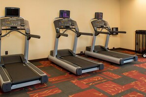 Stay active on the go with our fitness center, featuring three treadmills with digital displays.