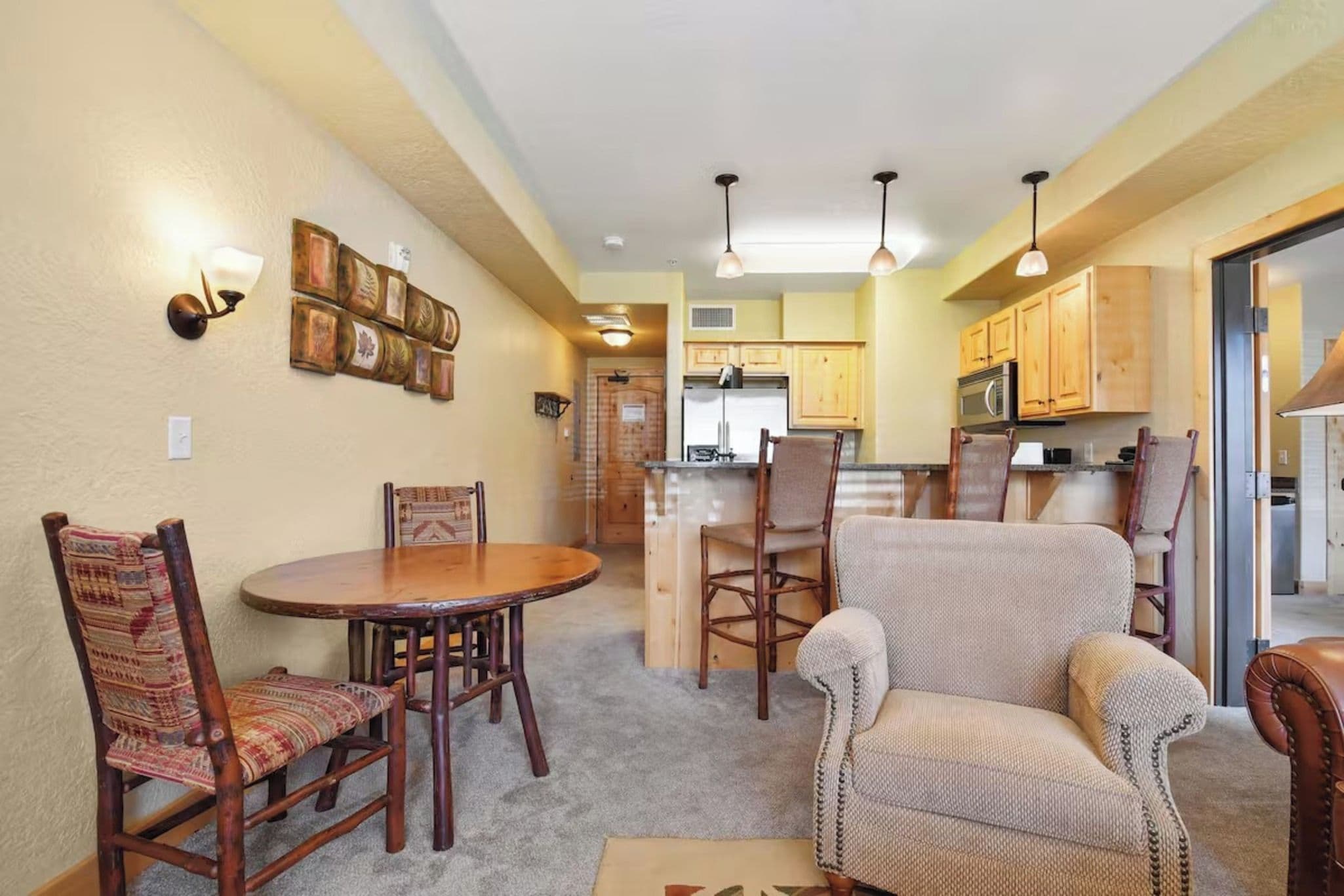 A compact living space with a dining area, kitchen, and seating arrangement.