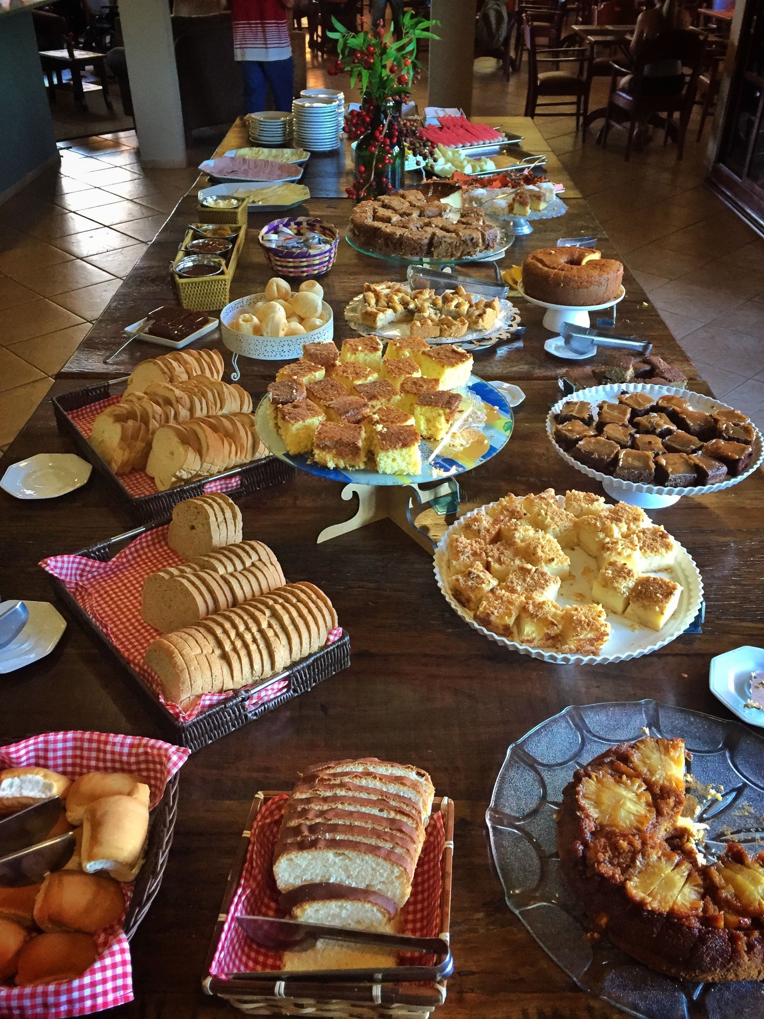 A buffet table with various baked goods and desserts.