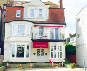 A two-story hotel with a balcony, a red awning, and a sign that reads "Welbeck Hotel." - The Welbeck Hotel (Westcliff-on-Sea)