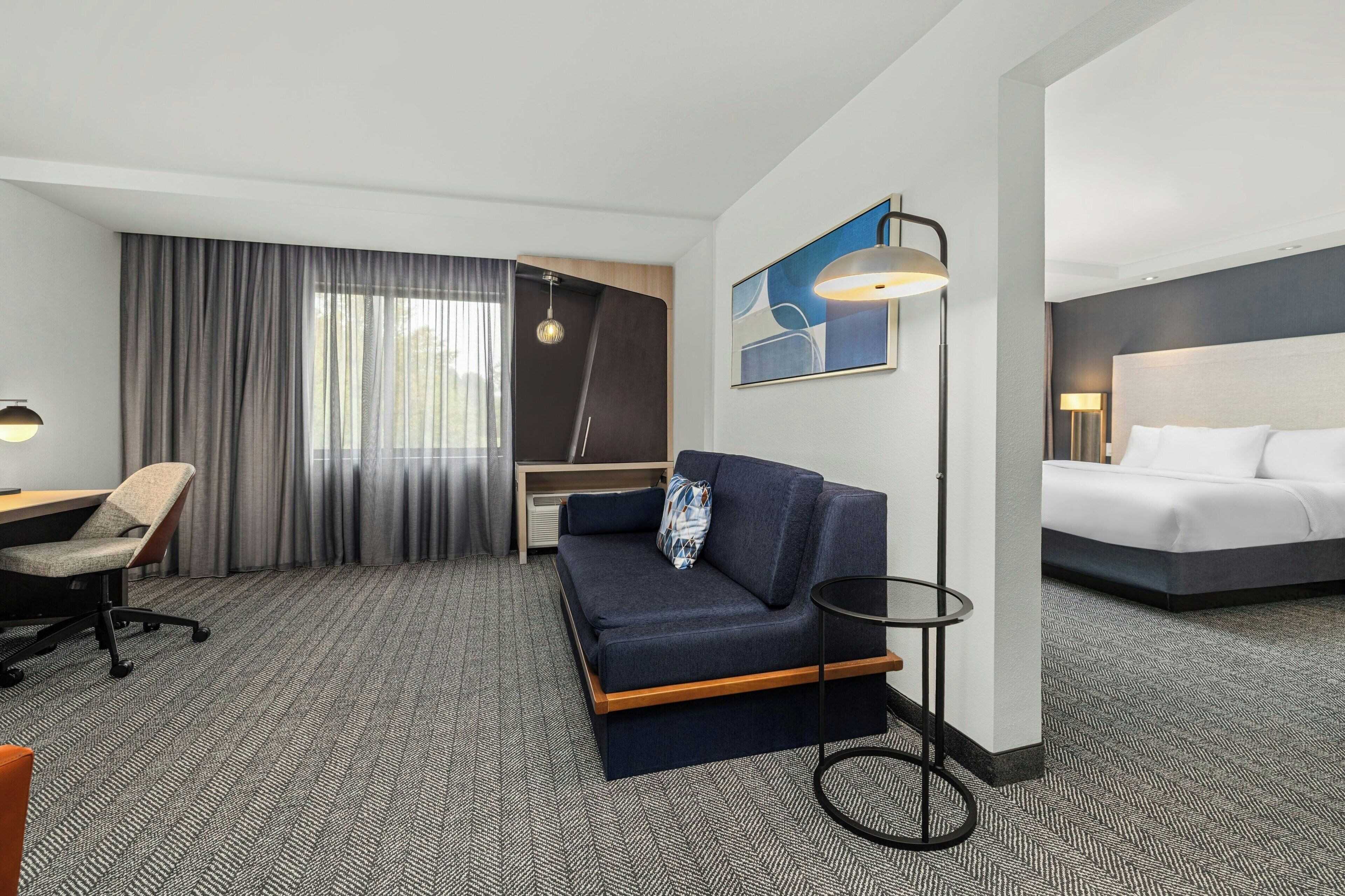 Hypo-allergenic bedding, desk, laptop workspace, blackout curtains