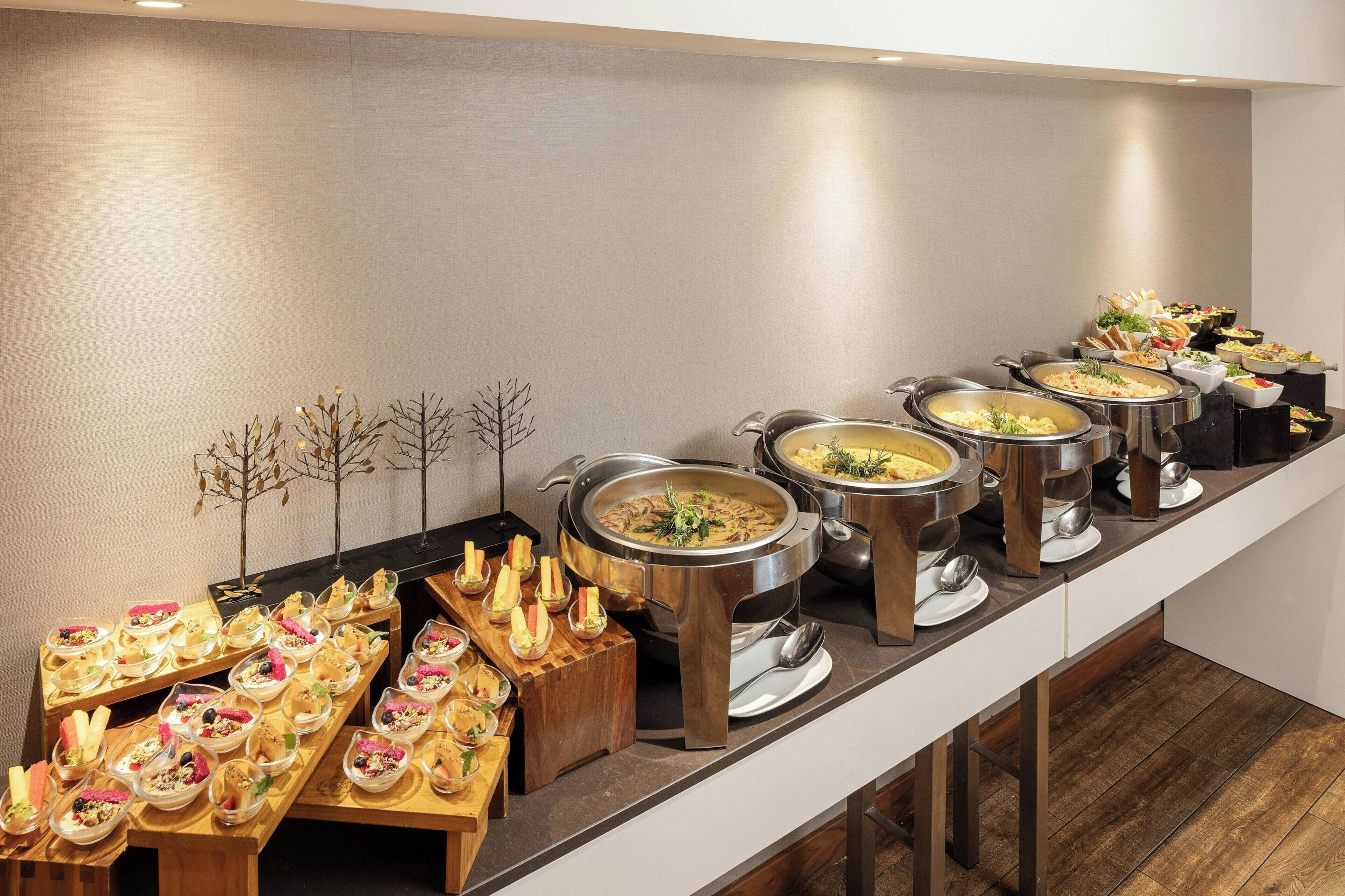 A buffet setup with various dishes and a long counter.