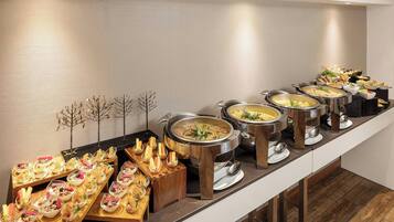 A buffet setup with various dishes and a long counter.