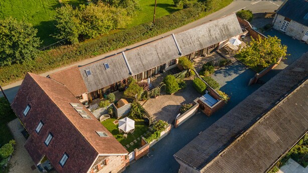 An aerial view of a building with multiple rooms, a courtyard, and a garden area. - Newclose Farm (Yarmouth)