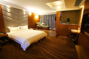 A hotel room with a large bed, a desk, a chair, a television, and a window with curtains. - Tulip Inn Chengdu Airport (Chengdu)