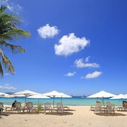 On the beach, white sand, sun-loungers