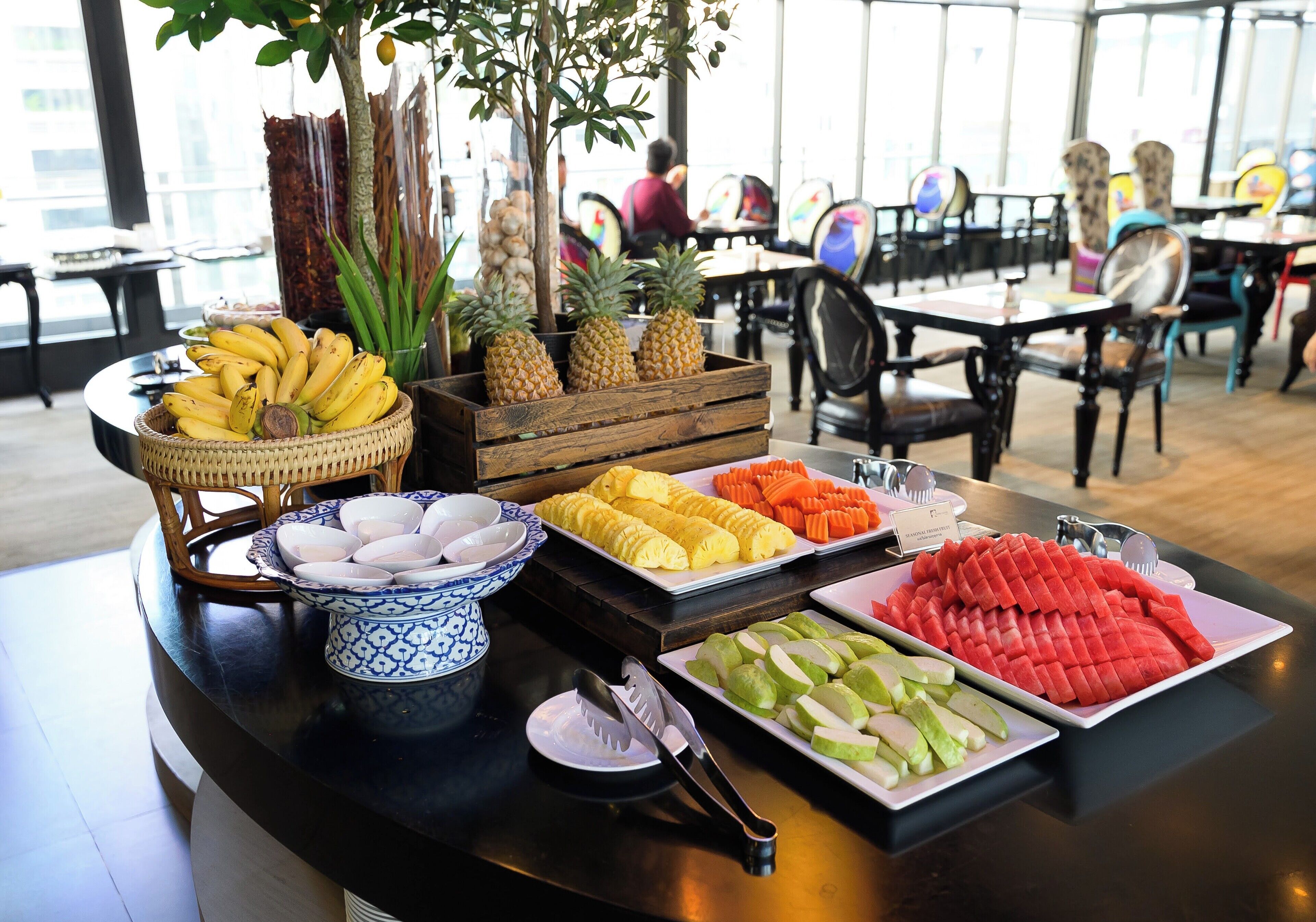 A buffet table with various fruits and vegetables.