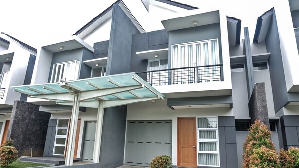 A modern multi-story residential building with a covered entryway, large windows, and a balcony. - De Orion Setiabudi Villa (Bandung)