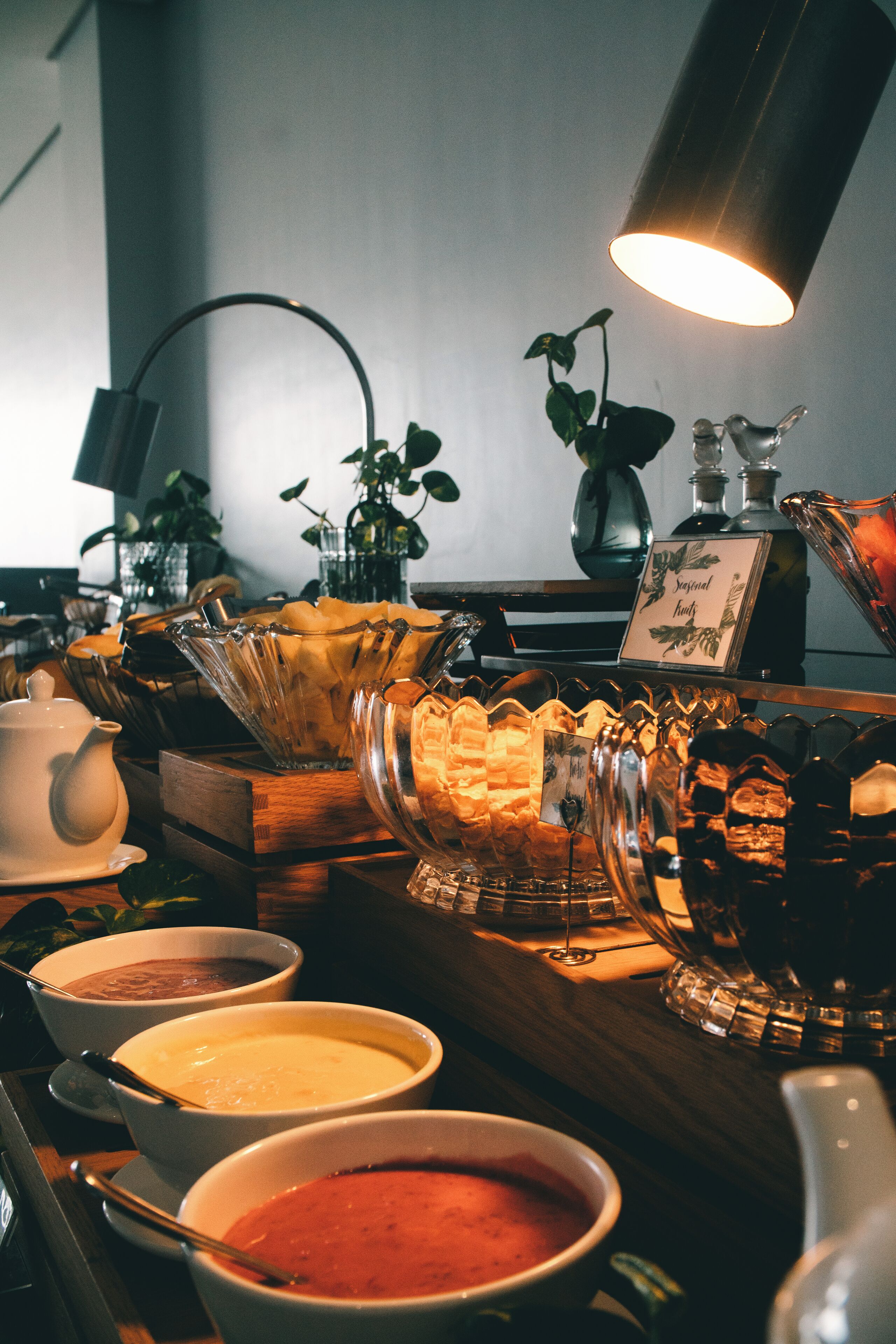 A buffet setup with various food items and a coffee station.