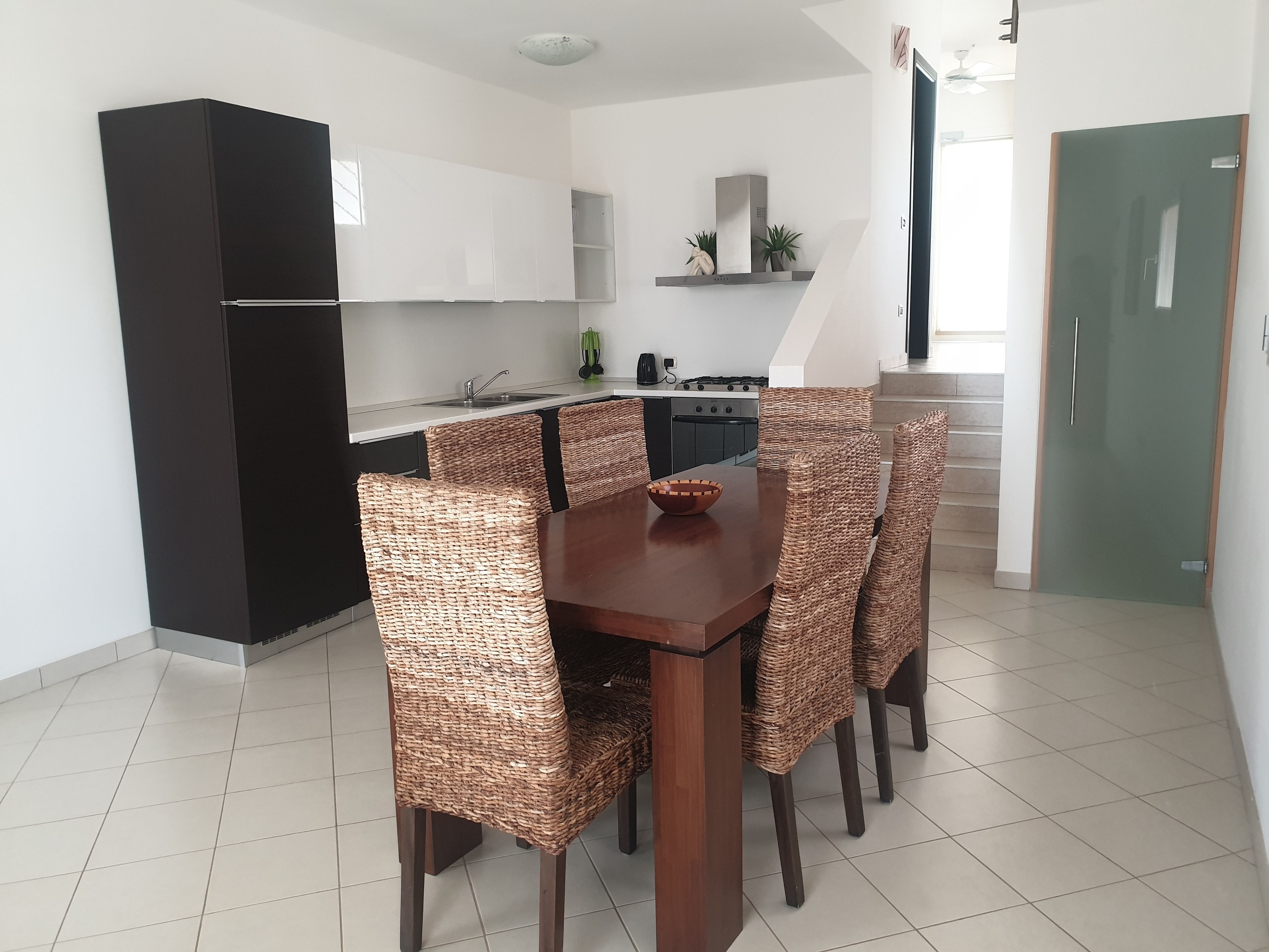 A modern kitchen with a dining area.