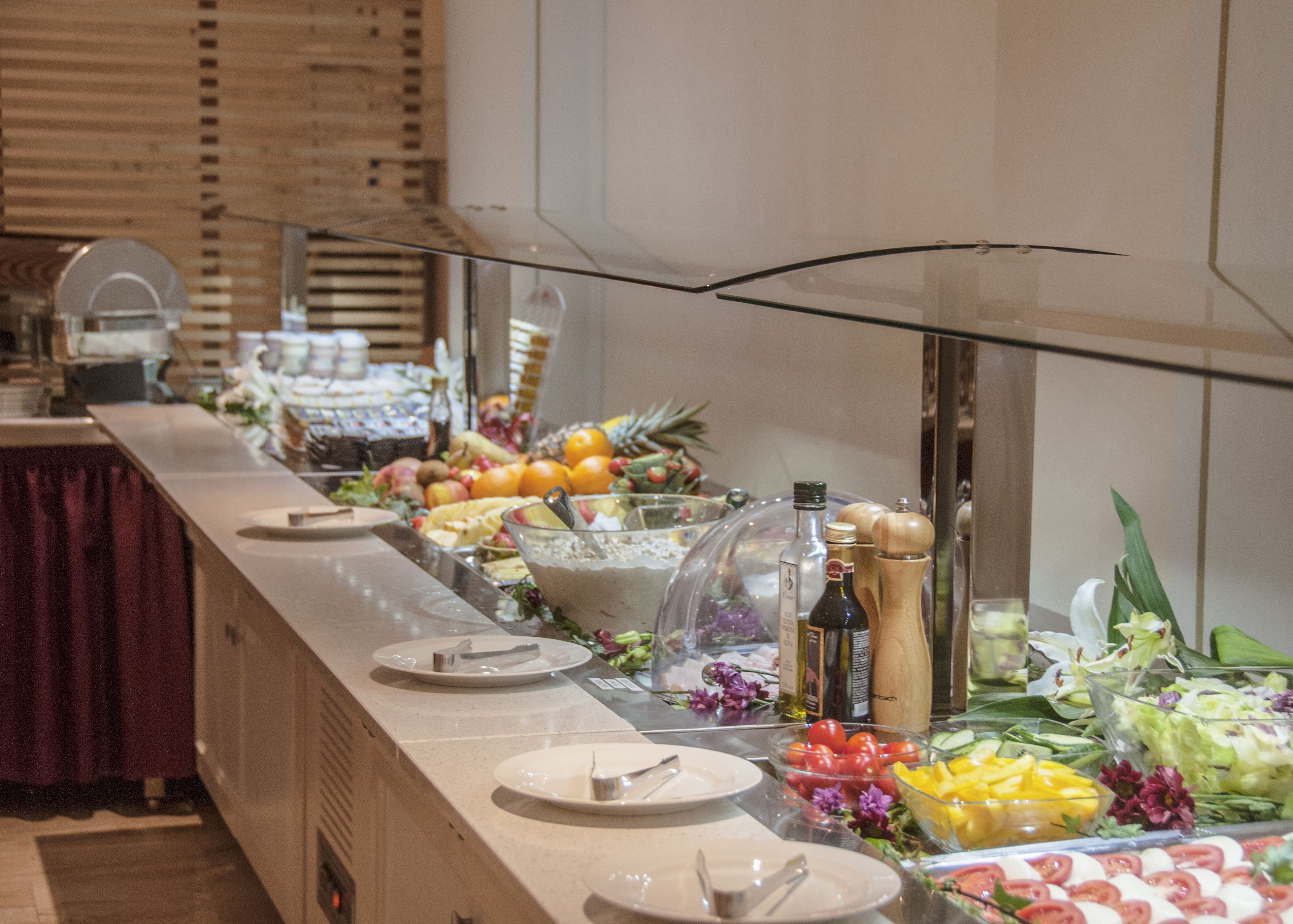 A buffet with various food items and condiments.