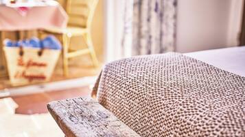 Relax in a cozy room with a comfortable seating area and dining space, featuring a large window and a wicker basket for personal items.
