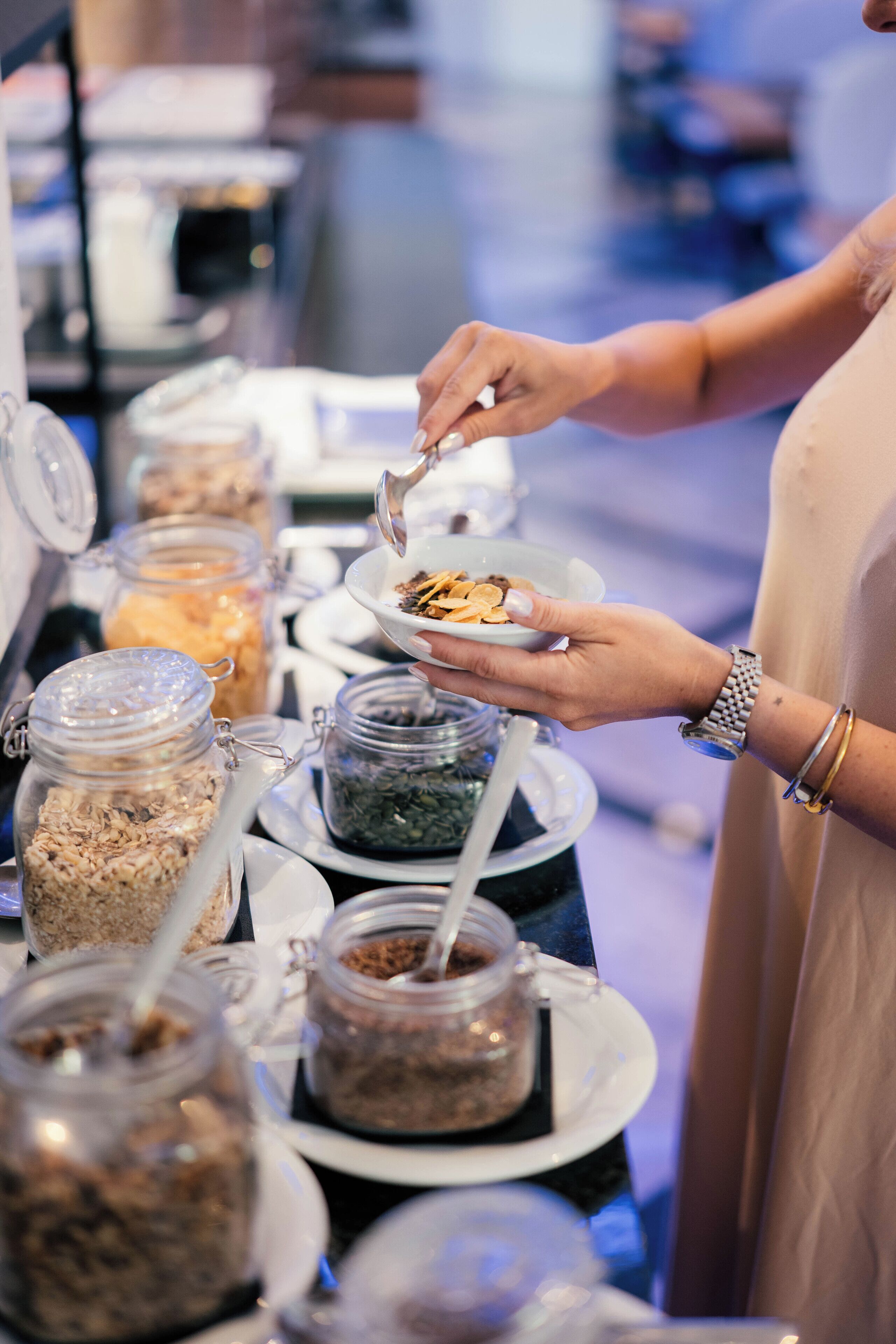 A buffet with various food items in jars and bowls.